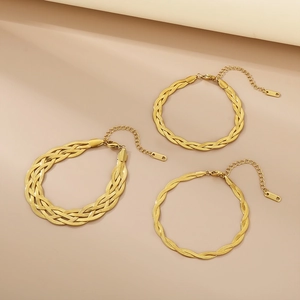 Detailed view of three gold braided snake chain bracelets with adjustable lobster clasps