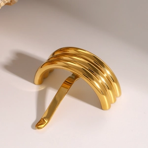 Close-up of a minimalist golden U-shaped hair fork pin with a smooth metallic finish