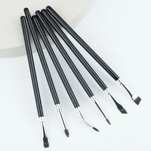 Flat lay of 6-piece eye makeup brush set with ergonomic liners on white background