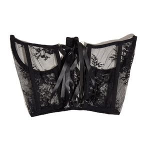 Black lace corset top with mesh detailing and ribbon lace-up back on white background
