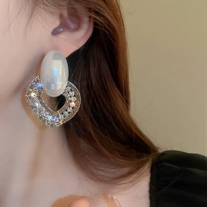 French vintage oversized heart shaped earrings with faux pearls and crystals on a model