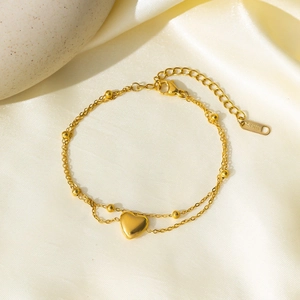 Double-layered gold stainless steel heart bracelet featuring polished beads and a pendant