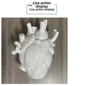 Detailed macro view of the realistic anatomical heart vase texture and white ceramic surface