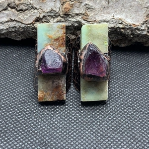 Detail view of vintage adjustable ring with green chrysoprase and purple amethyst raw stone
