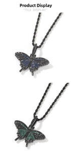 Detail of hip hop butterfly pendants with blue and green stones on black rope chains