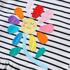 Striped kids dress featuring a vibrant colorful flower applique and a smiley face