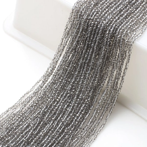 Macro shot of 2mm faceted grey glass beads for DIY necklaces and craft accessories