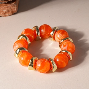 Detailed macro shot of vintage acrylic marble beads with golden geometric metal spacers