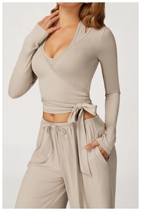 Detail of cross-wrap long sleeve yoga top with waist tie and drawstring joggers