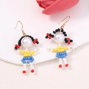 Detailed view of handmade beaded earrings in cute cartoon girl shape with white pearl top