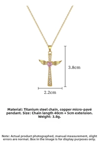 Detail of wing cross necklace with a pink heart gemstone and zircon pavé finish