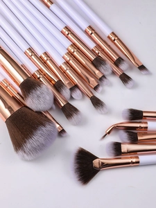 Macro view of professional 20-piece makeup brush set with rose gold ferrules and soft bristles