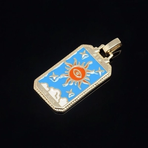 Detail of The Sun tarot card pendant with colorful enamel and crystal borders