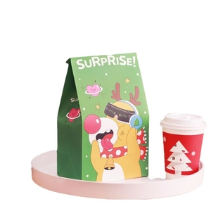 Christmas gift paper bag with cartoon reindeer and Surprise text on white tray