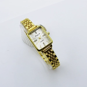 Detail of square gold metal watch with rhinestone markers on white sunray dial
