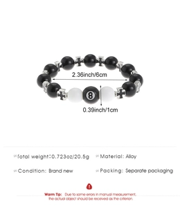 Macro shot of gothic beaded bracelet with black number 8 bead and alloy cross charms
