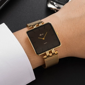 Classic square gold quartz watch with stainless steel mesh band worn on a wrist