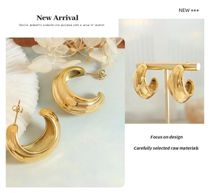 Detailed view of chunky 18k gold plated C-shaped hoop earrings with a high-polished finish
