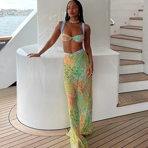 Detail of paisley print vacation set with bikini top and long skirt on a yacht deck
