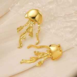 Detail of jellyfish style gold earrings with textured metal tentacles on wavy glass