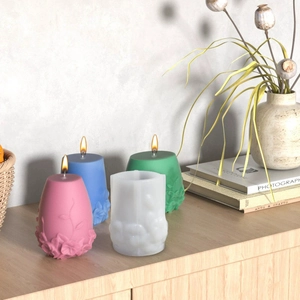 Detail of DIY silicone mold and textured cylindrical candles with floral relief patterns