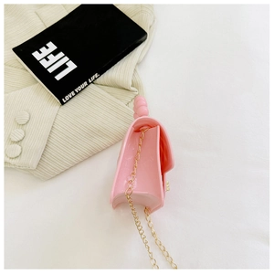 Pink jelly handbag with elegant pearl handle and gold chain strap close-up detail