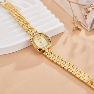 Elegant gold vintage tonneau-shaped women's watch with quartz movement on decorative pedestal