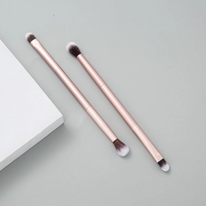 Set of two dual-ended rose gold makeup brushes with white and brown ombre bristles