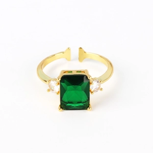 Macro view of emerald cut green stone and gold plating detail on adjustable open ring