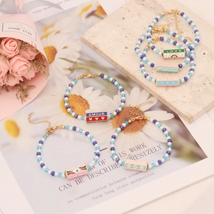 Handmade crystal beaded bracelets with blue and white colors and colorful enamel letter charms