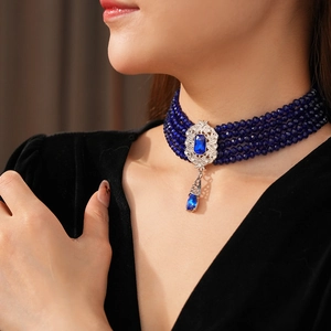 Detailed view of vintage multi-layer blue bead choker necklace with teardrop sapphire pendant