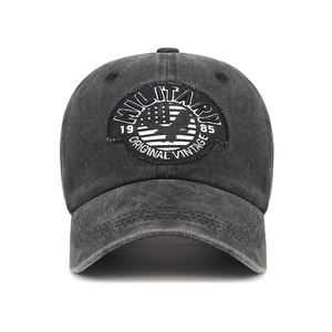 Vintage washed gray cotton baseball cap with embroidered military patch on white background