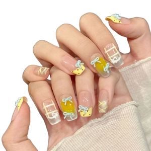 Pink and yellow bow press-on nails with 3D accents and gradient glitter on white background