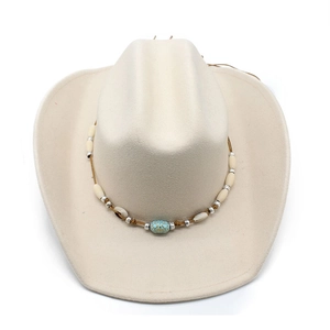 Detail of bohemian beaded band with turquoise on beige felt western cowboy hat