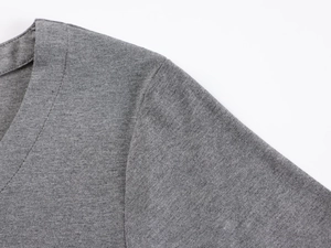 Close-up detail of the deep grey V-neckline and fine knitted texture of the slim fit shirt