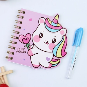 Detail of cartoon unicorn spiral notebook with shaped cover and matching blue ballpoint pen