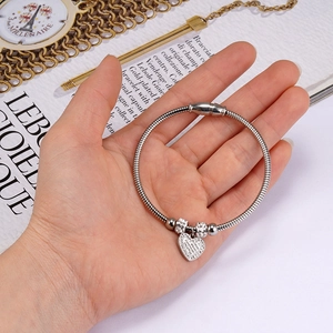 Silver snake chain bracelet with textured heart pendant and sparkling zircon beads