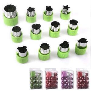 12-piece stainless steel cookie cutter set with green hand guards for fruits and vegetables