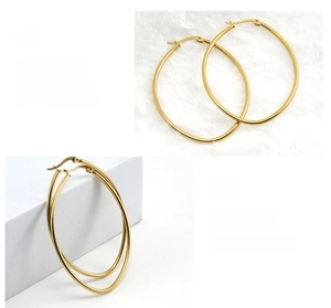 Detail of 18K gold plated titanium steel hoop earrings with polished mirror finish