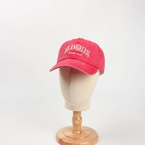 Detail of red washed cotton baseball cap featuring white Los Angeles vintage embroidery