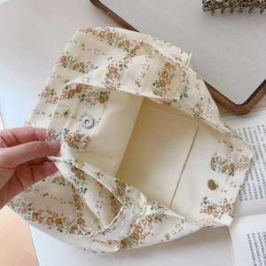 Close-up of small floral cotton hobo bag with magnetic buckle and interior pocket