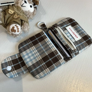 Detail of plaid coin purse featuring zip pocket, card slots and plastic hanging ring
