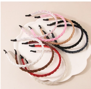Detailed view of colorful beaded headbands arranged on a white cloud-shaped tray