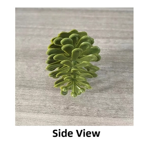 Side view of artificial green pine cone succulent decoration on gray wood texture