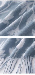 Detail view of blue and white leaf pattern cashmere-feel scarf with elegant soft fringes