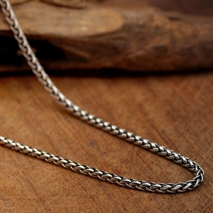 Minimalist silver titanium steel Cuban chain necklace for men and women on wood