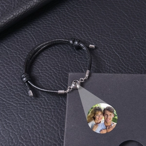 Macro detail of custom projection stone showing couple photo on black woven bracelet