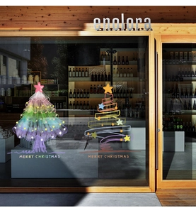 Close-up of colorful Christmas tree static window decals on a shop glass window