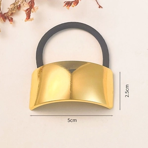 Detail view of a gold curved metal ponytail cuff with dimensions 2.5cm by 5cm