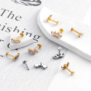 Titanium G23 labret studs set with moon and leaf designs in gold and silver plating